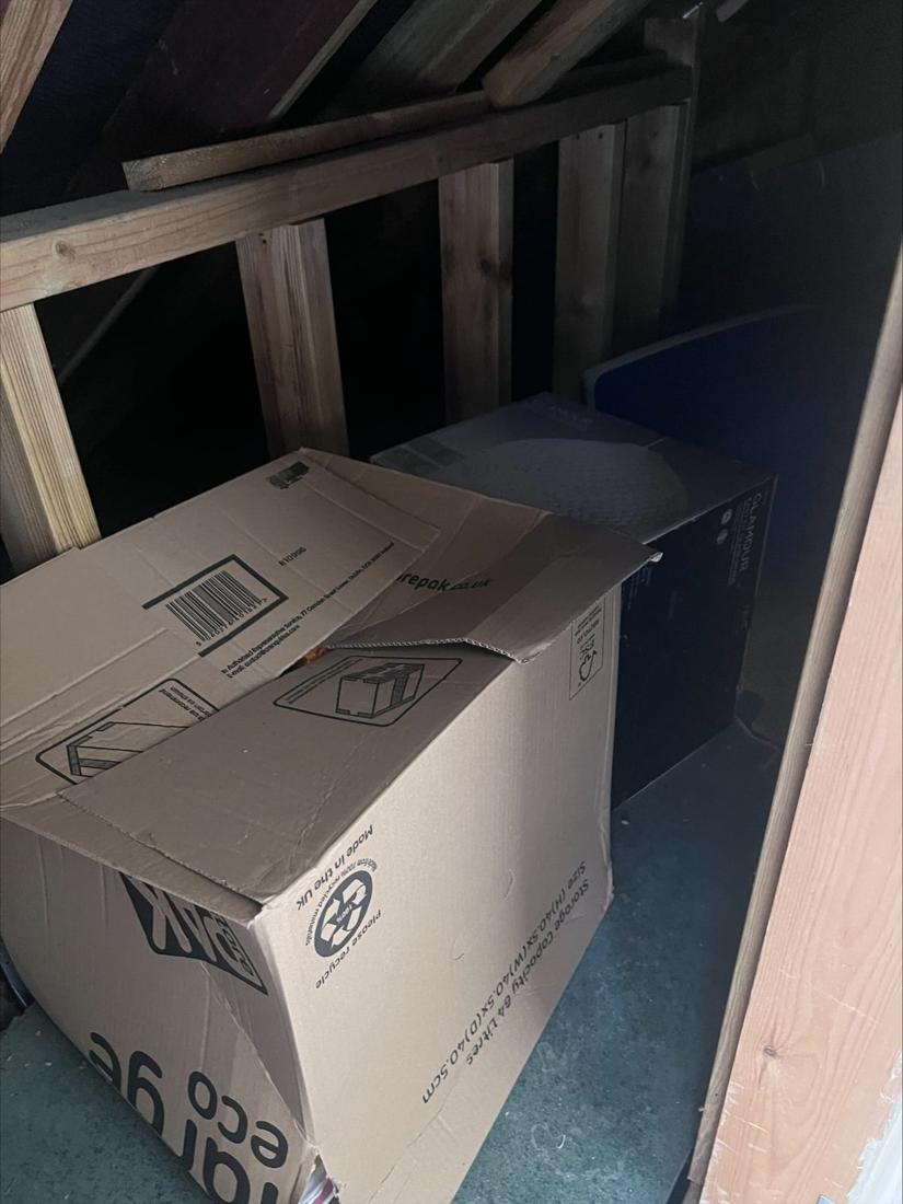 Boxes stacked in a loft space ready for clearance