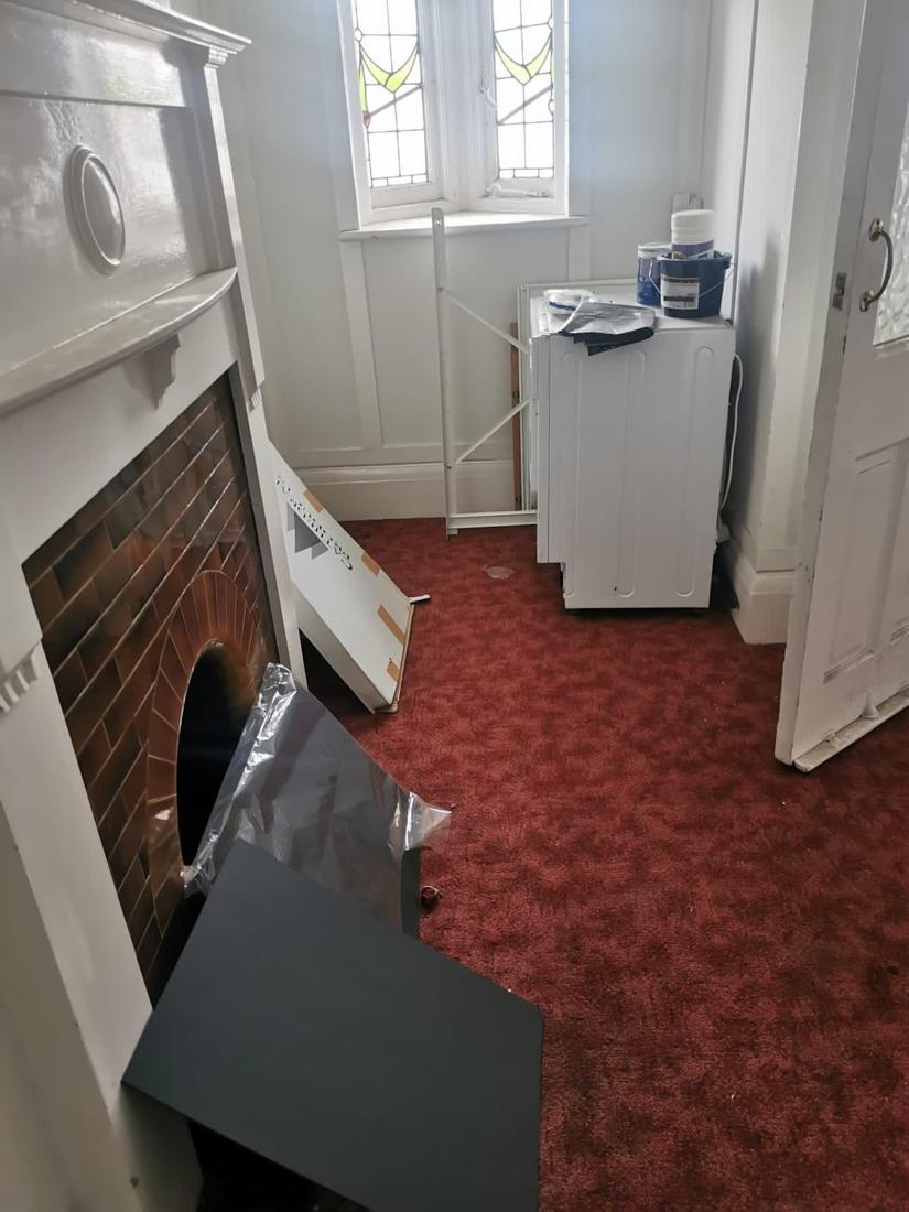 Room with appliance and boards before clearance