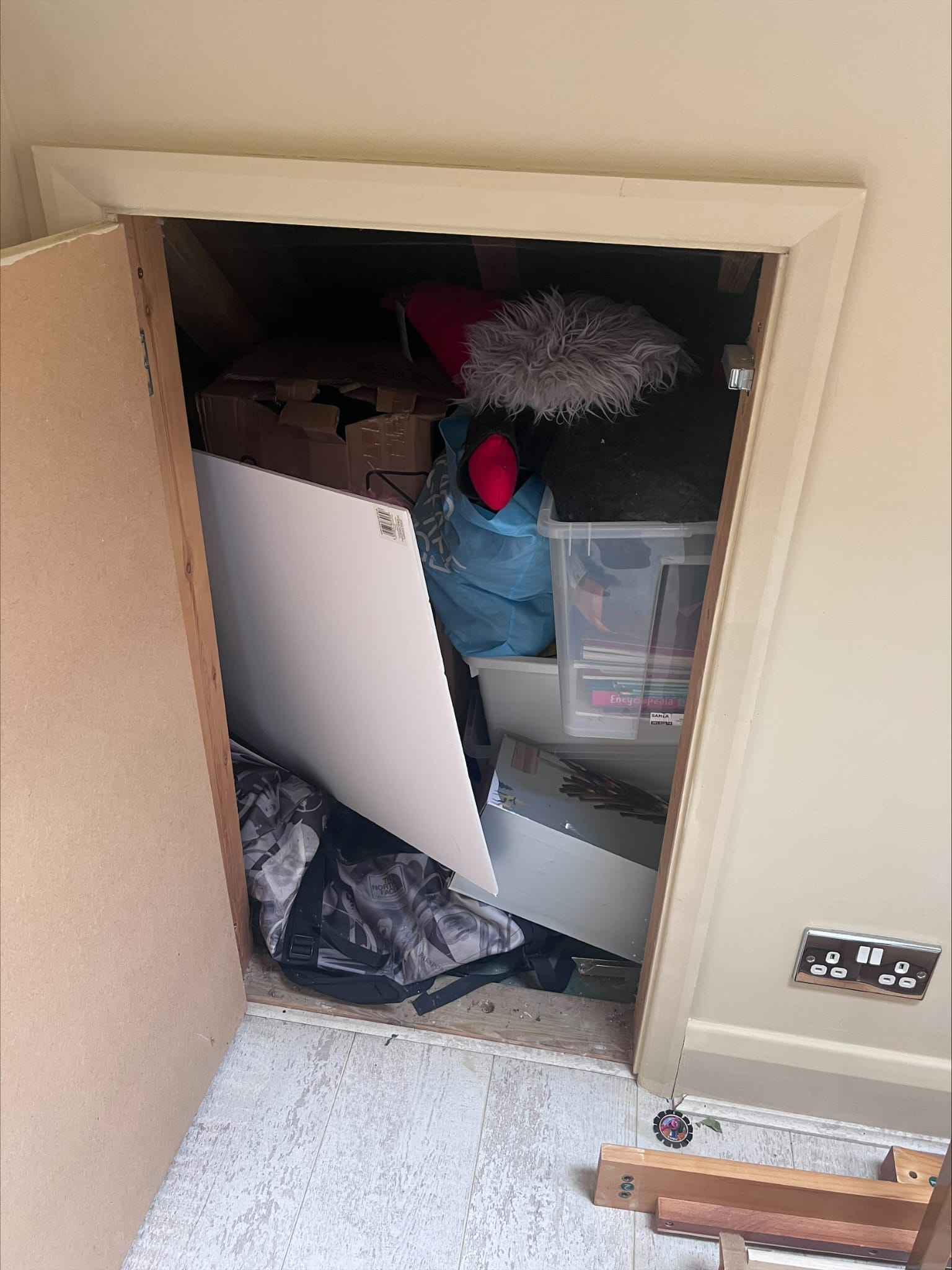 Overfilled household cupboard ready for clearance