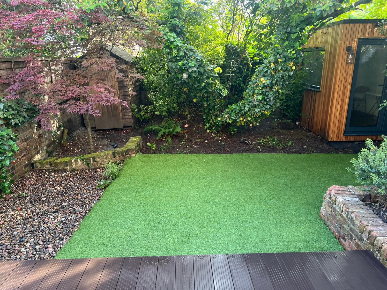 Finished artificial turf garden with tidy borders